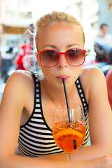 Image showing Woman with cocktail in street cafe.