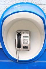 Image showing Blue pay-phone on wall