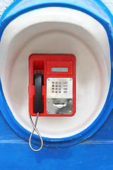 Image showing Red pay-phone on wall