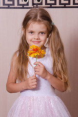 Image showing Girl in white dress with a flower