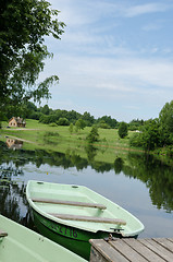 Image showing boat moored to wooden footbridge at lake shore 