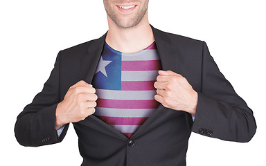 Image showing Businessman opening suit to reveal shirt with flag