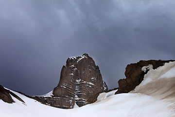 Image showing Snowy rocks and storm clouds