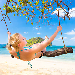 Image showing Lady swinging on the tropical beach