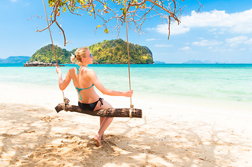 Image showing Lady swinging on the tropical beach
