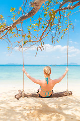 Image showing Lady swinging on the tropical beach