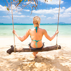 Image showing Lady swinging on the tropical beach