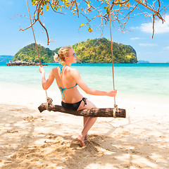 Image showing Lady swinging on the tropical beach