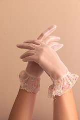 Image showing female hands modeling vintage lace gloves