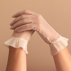 Image showing female hands modeling vintage sheer gloves