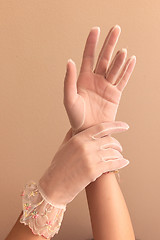 Image showing womans hands modeling vintage lace gloves