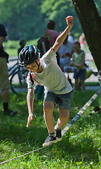 Image showing Little boy balancing on a tightrope