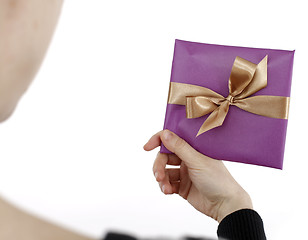 Image showing Young woman holding a present