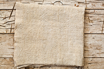 Image showing cotton napkin on old wooden table