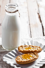 Image showing bottle of milk and crackers with honey
