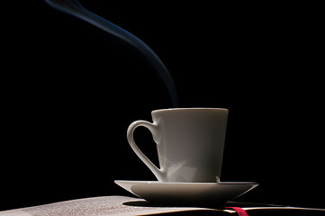 Image showing Coffee cup with coffee beans with old book