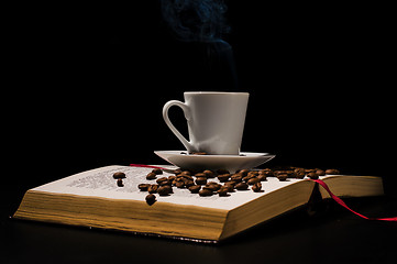 Image showing Coffee cup with coffee beans with old book