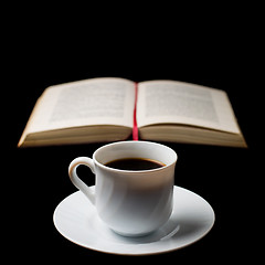 Image showing Coffee cup with coffee beans with old book