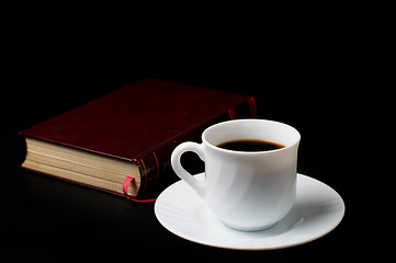 Image showing Coffee cup with coffee beans with old book