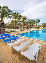 Image showing swimming pool and deck chairs at luxury resort