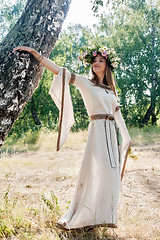 Image showing Beatiful woman in national dress and flower wreath