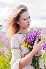 Image showing Attractive sad girl on meadow