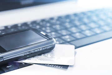 Image showing Credit cards and mobile phone on the laptop