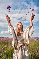 Image showing Beautiful woman relaxing on meadow with flowers