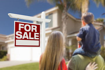 Image showing Family Facing For Sale Real Estate Sign and House