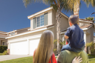 Image showing Mixed Race Young Family Looking At Beautiful Home