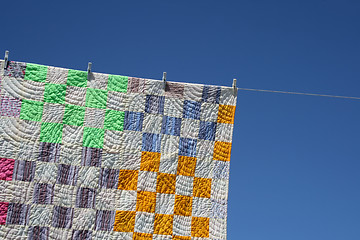 Image showing Patchwork counterpane on a clothes-line