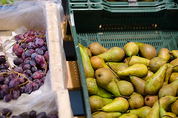 Image showing green pear and grapes bunch in plastic box store 