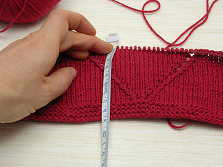 Image showing Red knitting with whole pattern and measuring tape