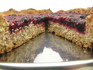 Image showing Cutted berry cake on a cake tray