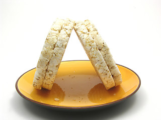 Image showing Slices of puffed rice arranged on a bowl of ceramik on white