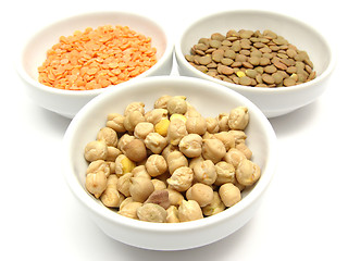 Image showing Three bowls of chinaware with garbanzos lentils and red lentils