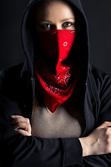 Image showing girl in black hood with a red shawl on his face