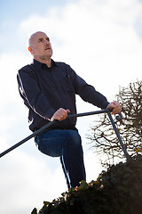 Image showing Thoughtful man sitting on a flight of steps