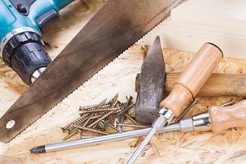 Image showing Drill with timber, screwdrivers and screws