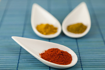 Image showing Dried ground spices in ceramic spoons