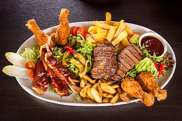 Image showing Platter of mixed meats, salad and French fries