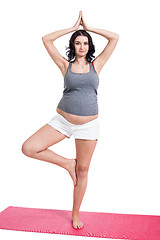 Image showing Active young pregnant woman doing yoga