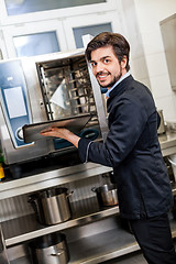 Image showing Chef cooking a vegetables stir fry over a hob