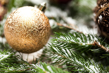 Image showing Gold Christmas ornament on leaves