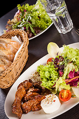 Image showing grilled beef stripes fresh salad and goat cheese