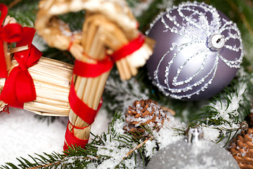 Image showing Silver Christmas bauble on a tree with snow