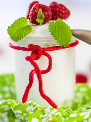 Image showing Raspberries and yoghurt or clotted cream