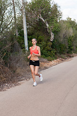 Image showing Fit young woman jogging