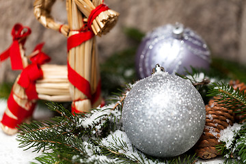 Image showing Silver Christmas bauble on a tree with snow