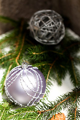 Image showing Silver Christmas ornaments in leaves